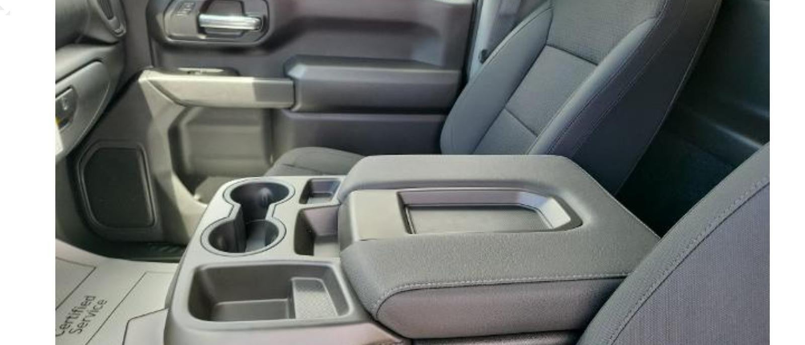 Close-up of the cup holder and hand rest in a Silverado 2500HD, highlighting the interior comfort features