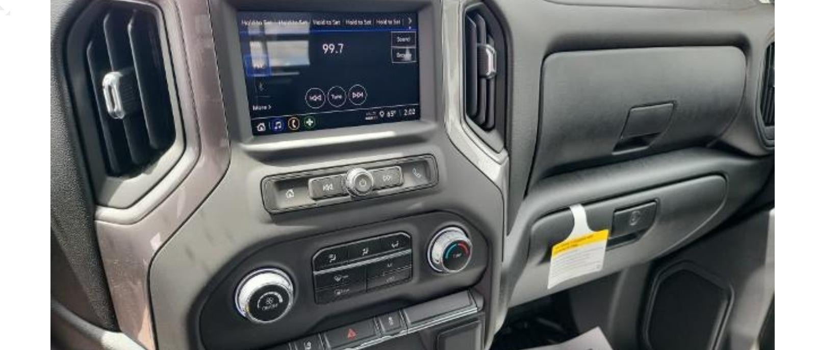Close-up of the dashboard and controls in a Silverado 2500HD, showcasing the vehicle's interior features and control panel