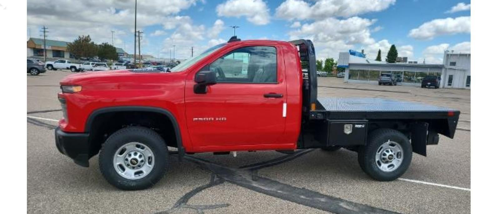 Side view of a red Silverado 2500HD truck standing, showcasing its bold design and powerful stance